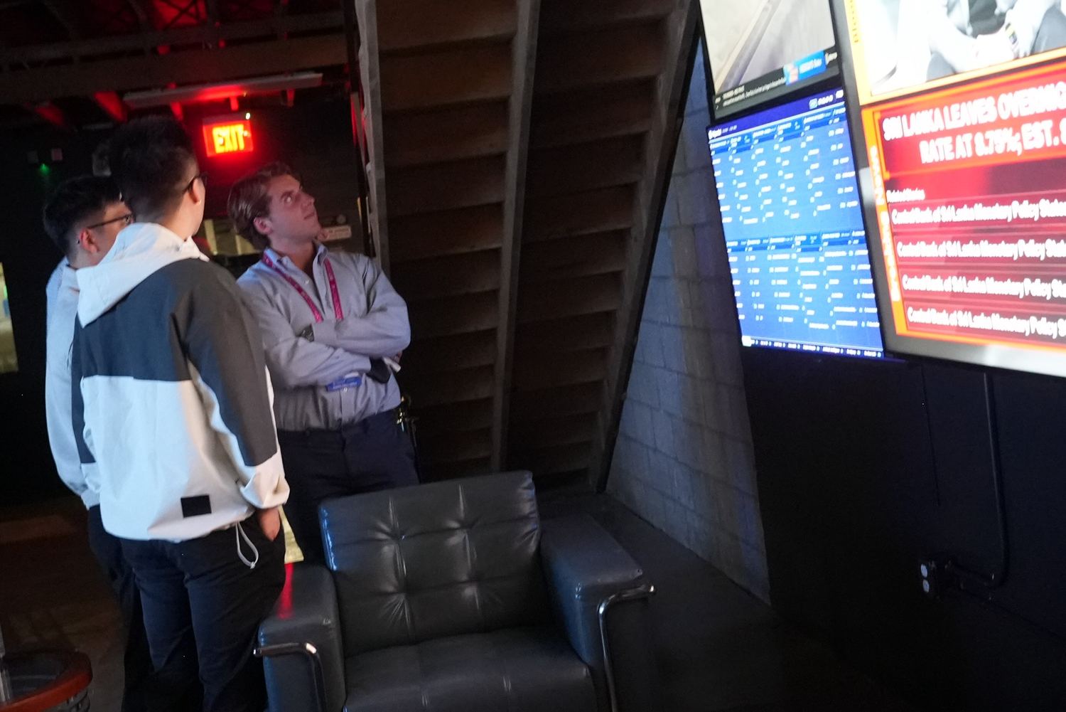 Guests checking the live market wall